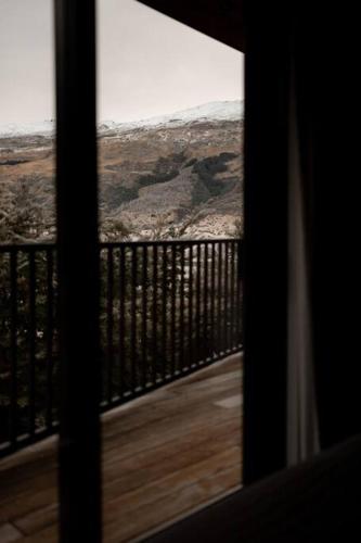 a view from a window of a balcony with a view at The Pines Guesthouse - new re-list in Arrowtown