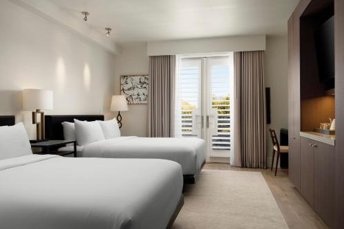 a hotel room with two beds and a balcony at HOTEL CERRO, Autograph Collection in San Luis Obispo