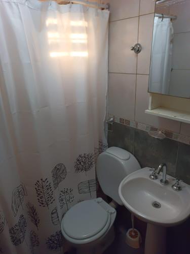 a small bathroom with a toilet and a sink at VMdormis in Neuquén
