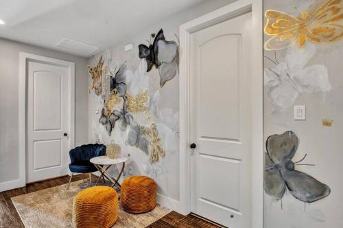 a room with a wall with butterflies on it at Timeless Beauty in Denton