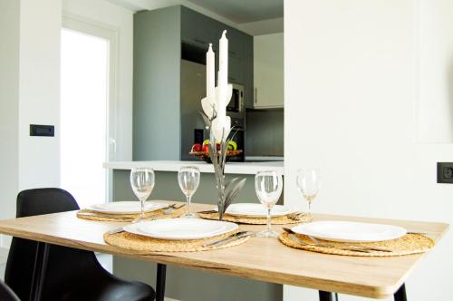 a dining room table with plates and wine glasses at Anna Maria's Maisonette I in Kardamaina