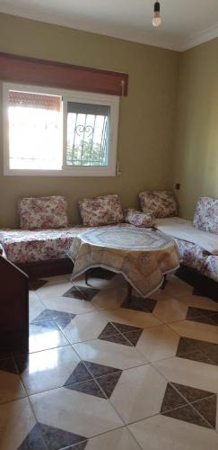 a room with couches and a table and a window at Yacoubi in Oued Laou