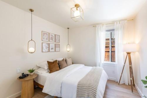 a white bedroom with a bed and a window at Casita Monterey Pet-Friendly Sonoma Escape in Sonoma