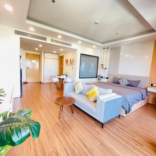a living room with a bed and a couch at FLC Ocean View Quy Nhon in Quy Nhon