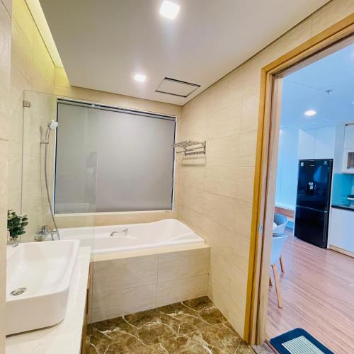 a bathroom with a bath tub and a sink at FLC Ocean View Quy Nhon in Quy Nhon