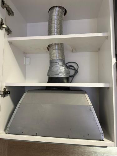 a roll of wire sitting on a shelf in a refrigerator at Sunrise apartment in Podgorica