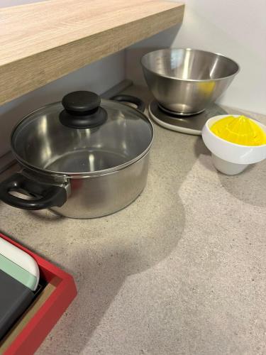 a pan on a counter with a bowl and a mixing bowl at Sunrise apartment in Podgorica