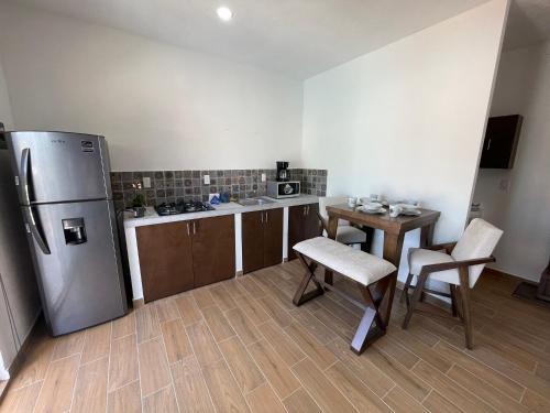 a kitchen with a refrigerator and a table and chairs at Frida Kahlo in Bucerías