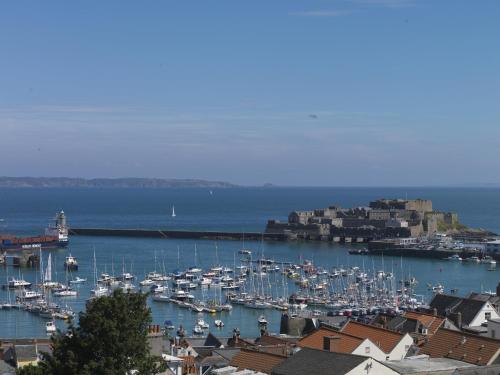 a harbor filled with lots of boats in the water at The Old Government House Hotel & Spa in St Peter Port