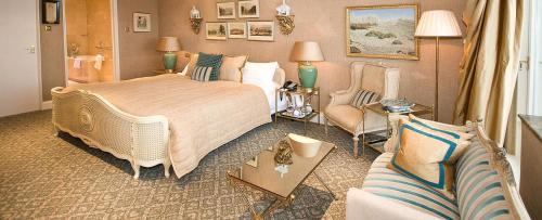 a hotel room with a bed and a couch at The Old Government House Hotel & Spa in St Peter Port