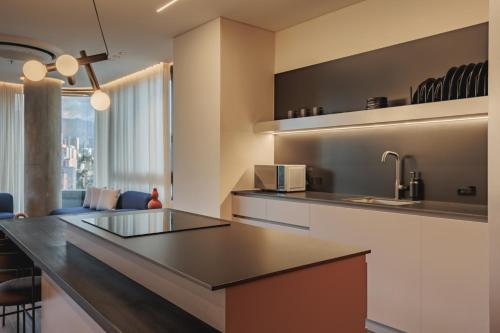 a kitchen with a large island in a room at Nock - Reserved Residences in Medellín