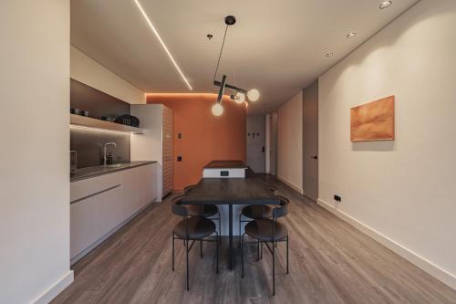 a kitchen and dining room with a table and chairs at Nock - Reserved Residences in Medellín