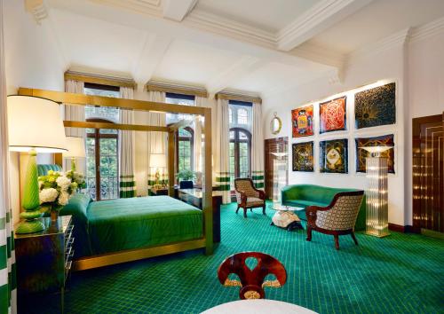 a bedroom with a green bed and a green carpet at Milestone Hotel Kensington in London