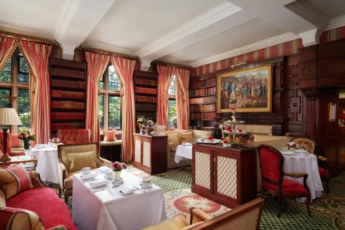 a restaurant with tables and chairs in a room at Milestone Hotel Kensington in London