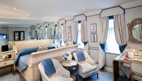 a bedroom with a bed and two chairs at Milestone Hotel Kensington in London