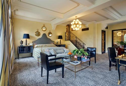 a living room with a bed and a couch at Milestone Hotel Kensington in London