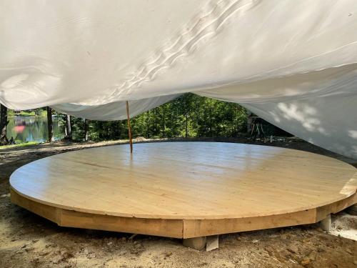 a circular wooden table under a white tent at Alderbrook Yurt in Warrensburg