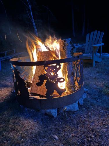 a fire pit with a teddy bear on it at Alderbrook Yurt in Warrensburg