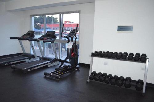 a gym with two treadmills and two machines at Simply the most comfortable place next to Boca Chica beach in Boca Chica