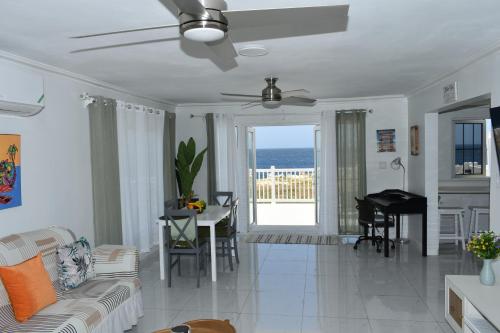 a living room with a couch and a table at Irie Vibes Ocean View in Negril