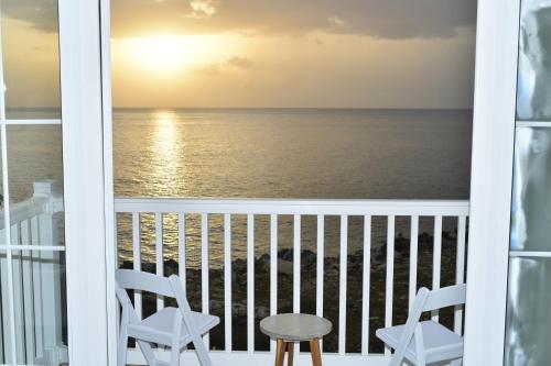a view of the ocean from a balcony at Irie Vibes Ocean View in Negril