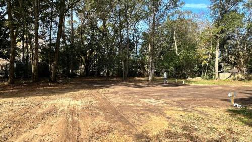a dirt road in the middle of a forest at RV space in Summerville