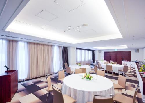 a large room with tables and chairs in it at Mercure Okinawa Naha in Naha