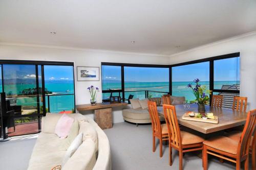 a living room with a couch and a table at Ocean Dreaming - Nelson Waterfront in Nelson