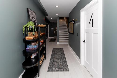 a hallway with a black wall and a staircase at Inn At Fulton Boutique Hotel in Sandusky