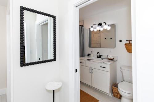 a bathroom with a mirror and a sink at Inn At Fulton Boutique Hotel in Sandusky
