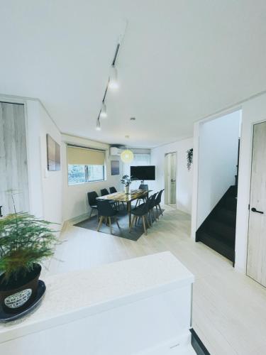 a living room with a table and a dining room at 下町立石駅近民泊美幸 in Tokyo