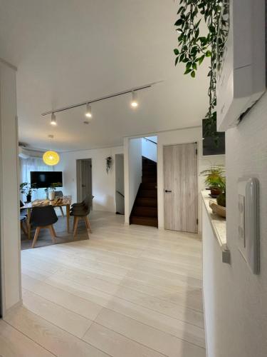 a living room with a kitchen and a dining room at 下町立石駅近民泊美幸 in Tokyo