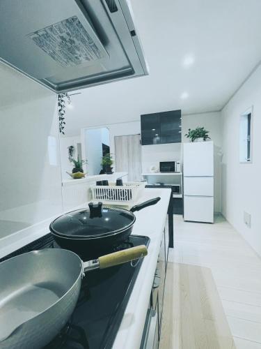a kitchen with a sink and a bowl on a counter at 下町立石駅近民泊美幸 in Tokyo