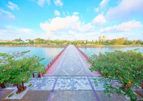 a bridge over a body of water with trees at Mercure Okinawa Naha in Naha