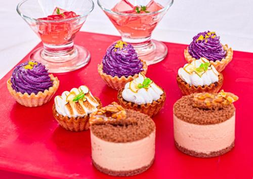 a group of cupcakes sitting on a red tray at Mercure Okinawa Naha in Naha