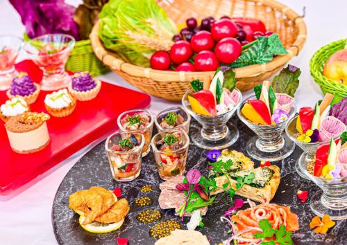 a table with a buffet of food and snacks at Mercure Okinawa Naha in Naha