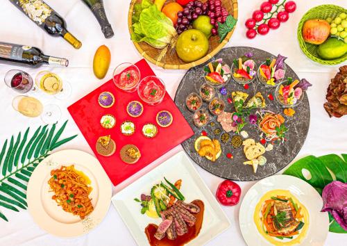 a table with many plates of food on it at Mercure Okinawa Naha in Naha
