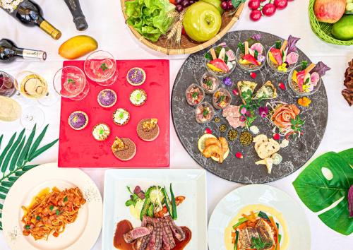 a table topped with plates of food and appetizers at Mercure Okinawa Naha in Naha
