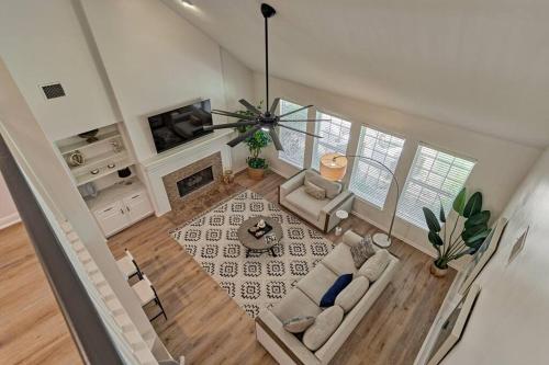 an overhead view of a living room with couches and a fireplace at New!4BR with Easy Access to all Woodlands Amenities in The Woodlands