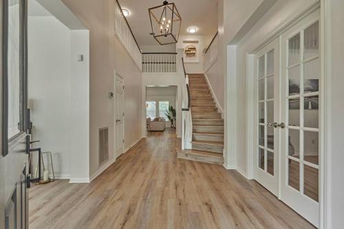 a hallway of a home with wooden floors and a staircase at New!4BR with Easy Access to all Woodlands Amenities in The Woodlands