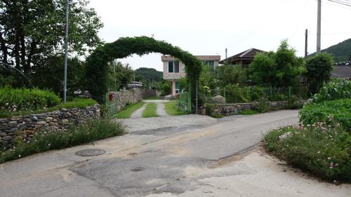 an empty road with an arch in front of a house at Buan sukranjeong pension in Buan