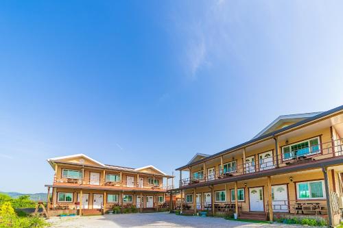 a row of apartment buildings with a blue sky in the background at Nonsan Sodam Pension in Nonsan