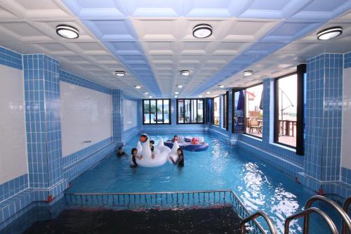a pool with a group of people riding on an inflatable at Uljin blue ara A pension in Uljin