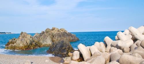 a group of rocks on a beach near the ocean at Ulsan Lighthouse Pension in Ulsan