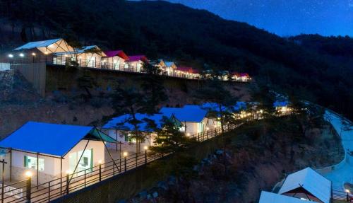a row of houses on a hill at night at Gurye Jirisan Hosu Resort Pension in Gurye