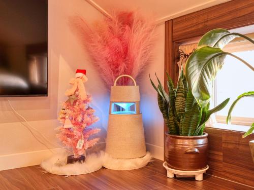 a room with a christmas tree and some feathers at Chuncheon Kerensia Pension in Chuncheon