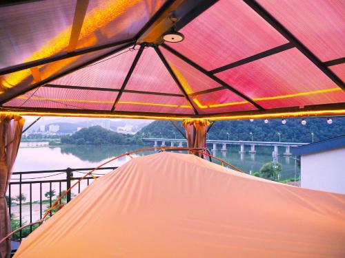 a view from inside a tent with a view of a river at Chuncheon Kerensia Pension in Chuncheon