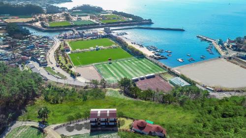 an aerial view of a park next to a body of water at Namhae New Island Pension in Namhae
