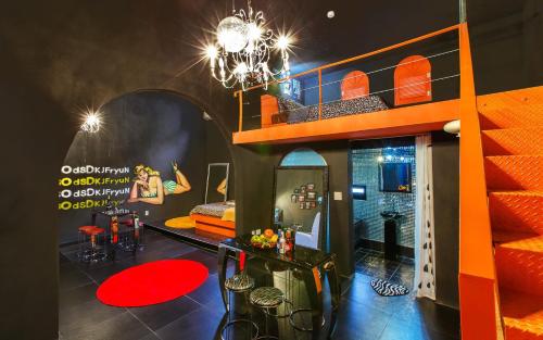 a room with an orange bunk bed and red carpet at Chuncheon Pier Star Pension in Chuncheon