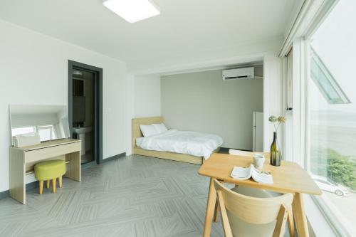 a bedroom with a bed and a desk and a table at Incheon donggeumdo hanguk villa in Incheon